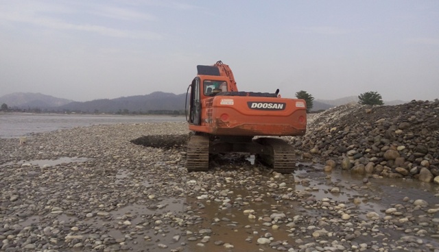 Heavy duty excavator on Ganga river bed